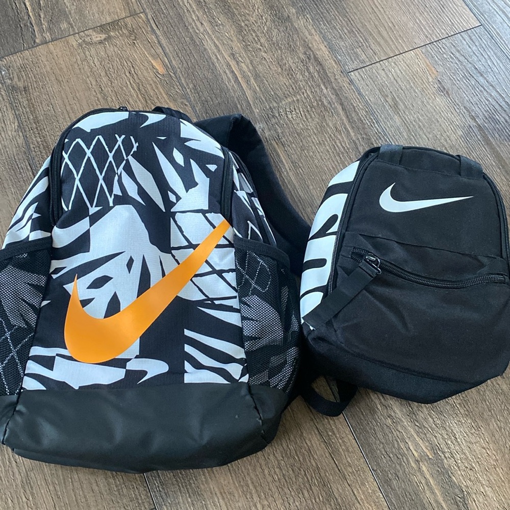 Nike Kids Black and White Backpack with Orange Swoosh